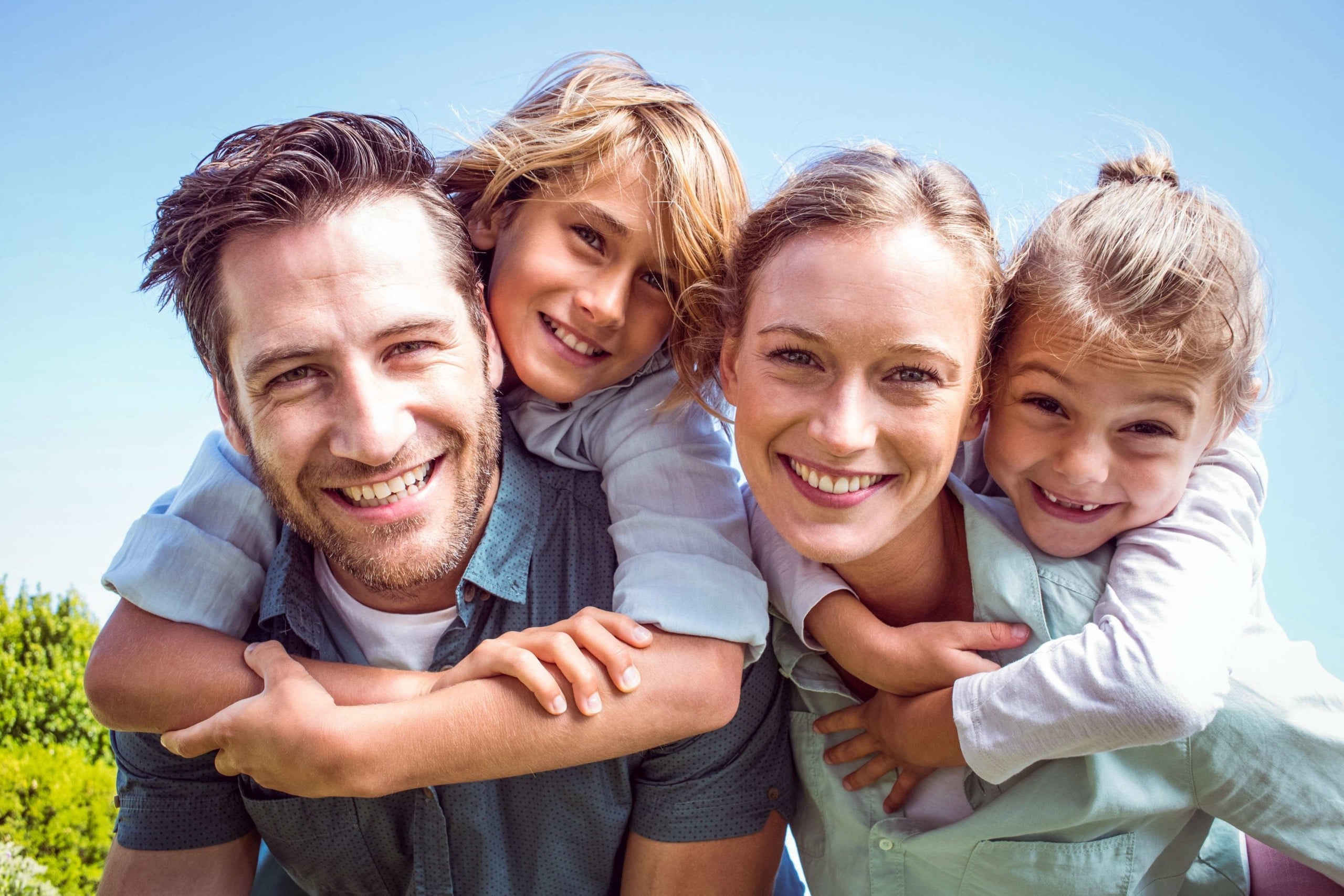 Family hugging and smiling