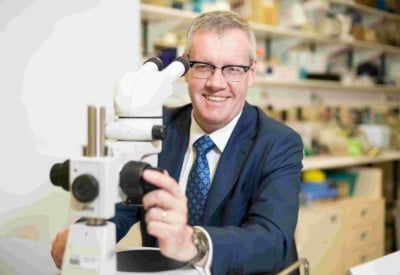 Professor Toby Coates with microscope