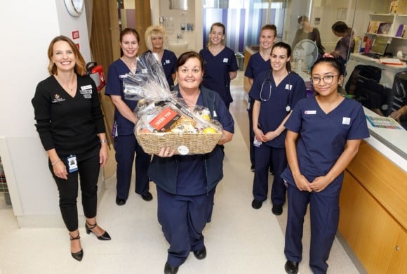 A group of hospital nurses holding a hamper