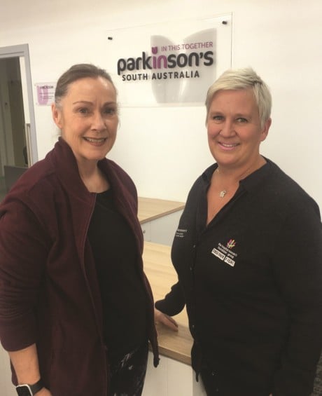 Kate and Joanne Dalton, the Parkinson's SA Clinical Nurse Consultant smile at the camera in the Parkinson's SA office