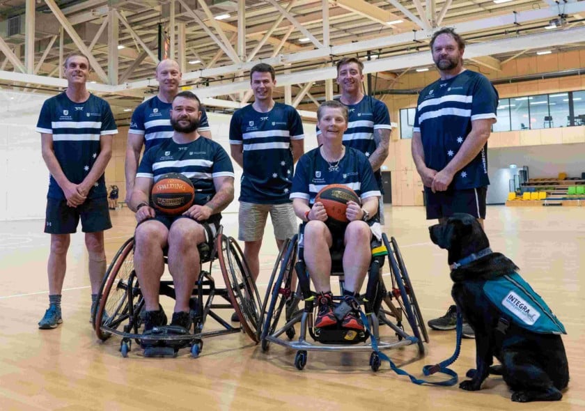 Athletes and wheelchair athletes on a basketball court