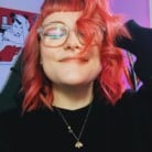 Woman smiling at camera with eyes closed taking a selfie
