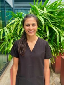 rehabilitation consultant Dr Subbuh Luker standing in front of green plants smiling