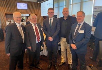 Group of men smiling at camera due to men's health announcement