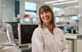 Dr Sarah Boyle smiling in research lab