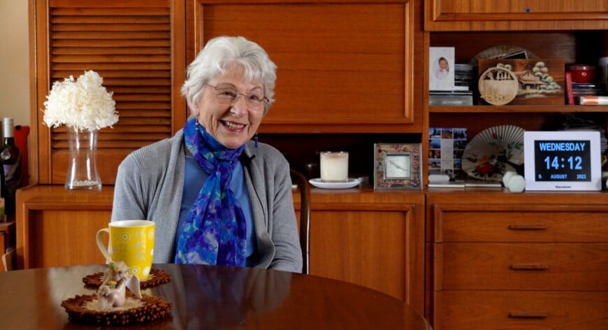 Eve, smiling at camera with a cup of tea, is leaving a legacy of health with a gift in her Will.