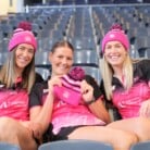 3 thunderbirds players sitting in stands wearing Play 4 Pink beanies
